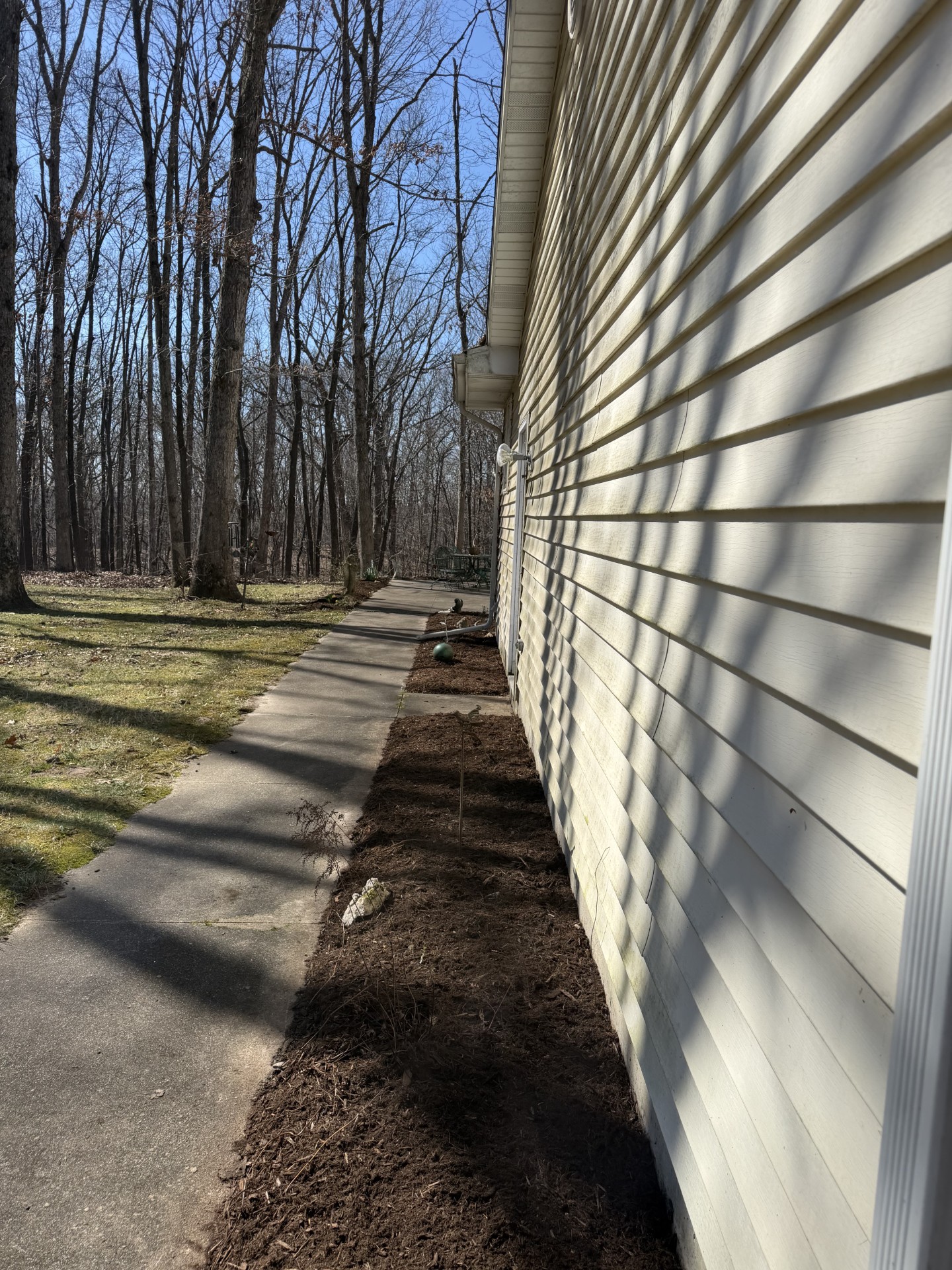 Cleaned and edged bed along a sidewalk after spring cleanup