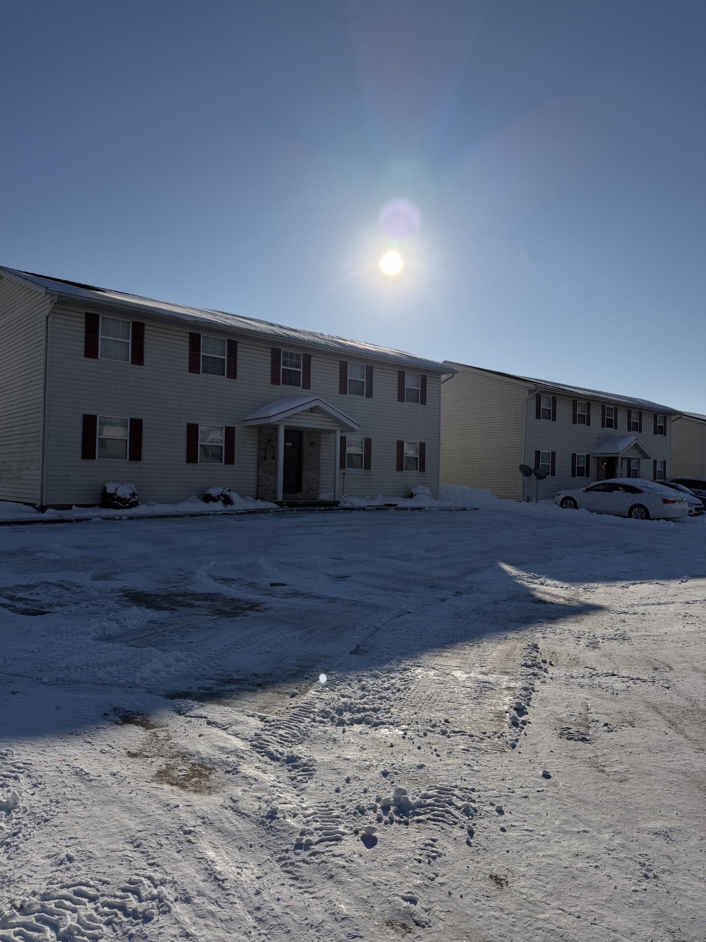 Cleared apartment parking lot after fresh snowfall